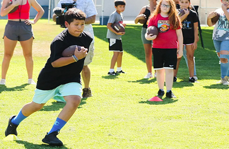 Student running with football